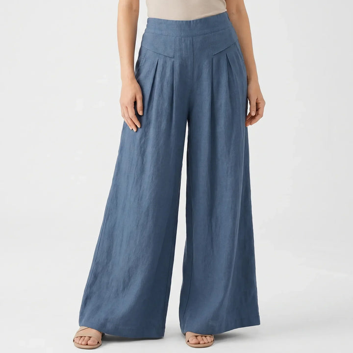 Close-up of women's high-rise wide leg pants with comfortable elastic waist and stylish pleats.