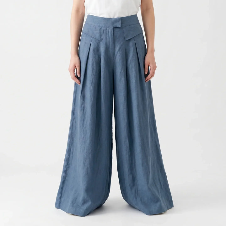 Woman walking in comfortable, flowy wide leg summer pants, showcasing relaxed fit and airy fabric movement.