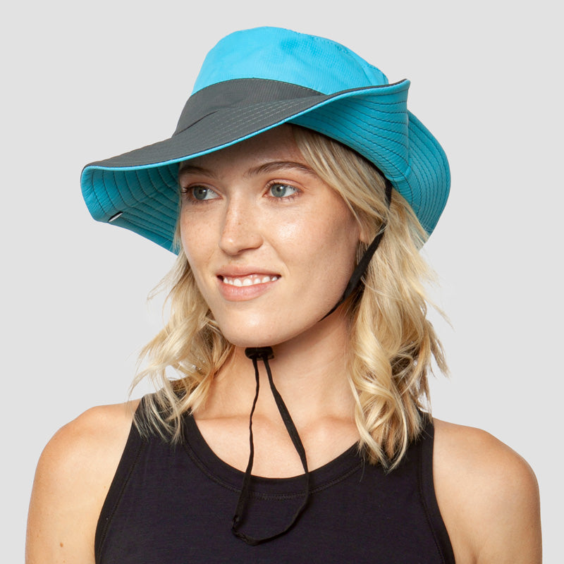 Compact foldable women's travel sun hat. UV protection, wide brim, & ponytail opening for easy packing.