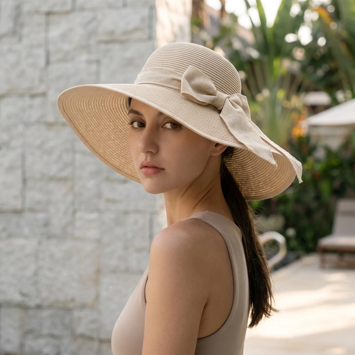 Women's foldable wide brim sun hat for beach & travel. Perfect summer vacation accessory.