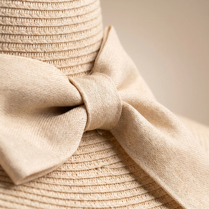 Foldable wide brim women's sun hat in khaki. Easy to pack for travel, beach & summer vacations.