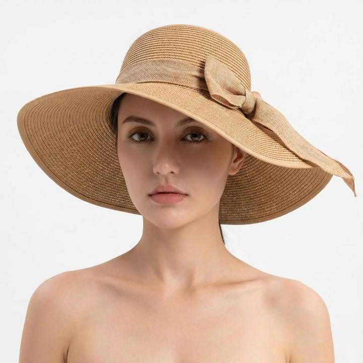 Stylish women's summer sun hat with wide brim, foldable for beach, travel & outdoor use.