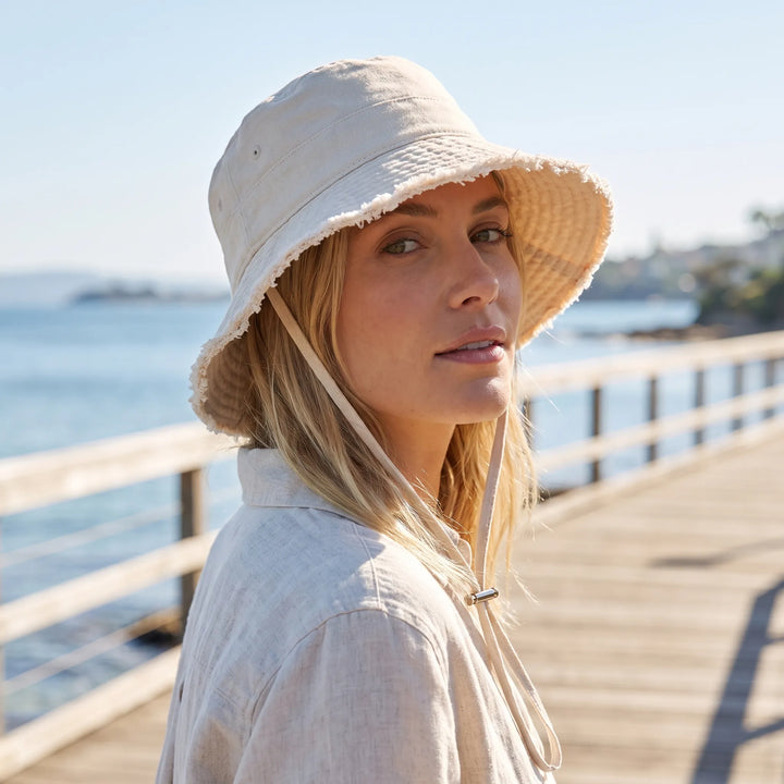 Women's frayed brim bucket hat, perfect for summer, beach, and sun protection. Casual & stylish.