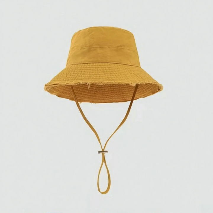 Versatile women's frayed brim summer hat. Offers sun protection and relaxed style for beach or travel.