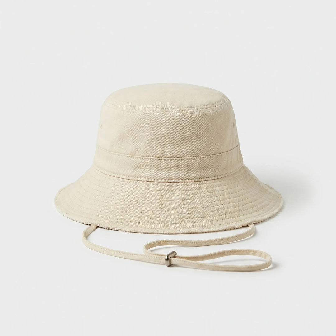 Relaxed women's bucket hat with a chic frayed brim. Ideal for beach days, travel, and sun safety.