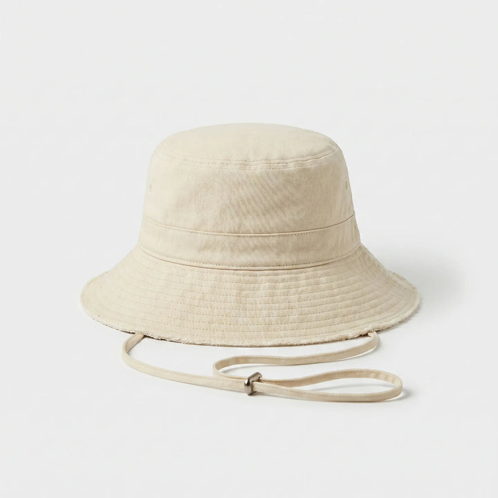 Relaxed women's bucket hat with a chic frayed brim. Ideal for beach days, travel, and sun safety.