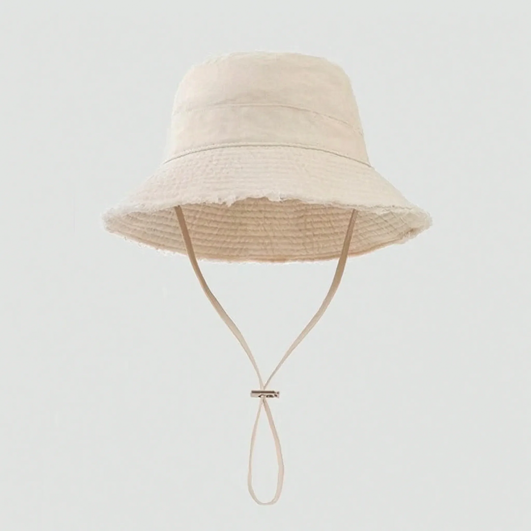 Chic women's frayed bucket hat for summer. Provides sun protection, ideal for beach, travel, and everyday.