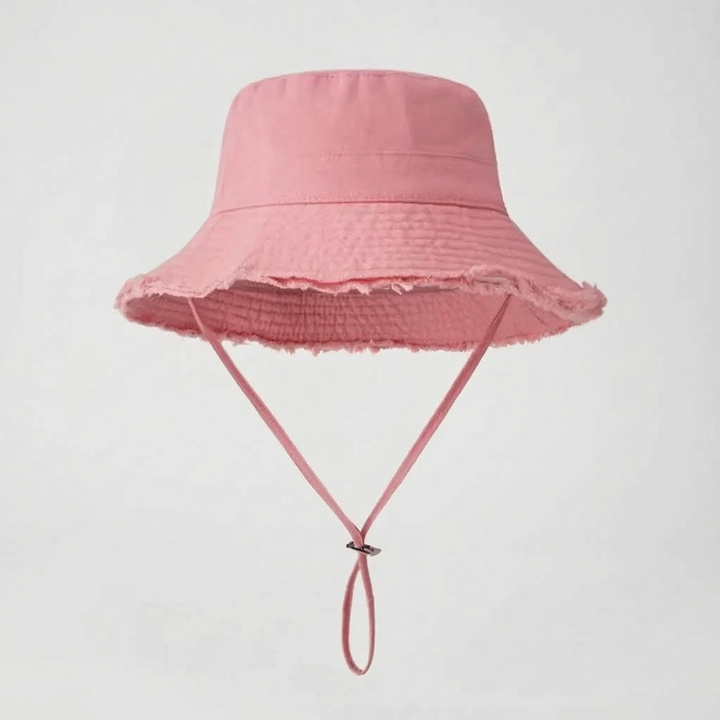 Trendsetting women's bucket hat with a raw, frayed brim. Your go-to for summer sun protection & style.