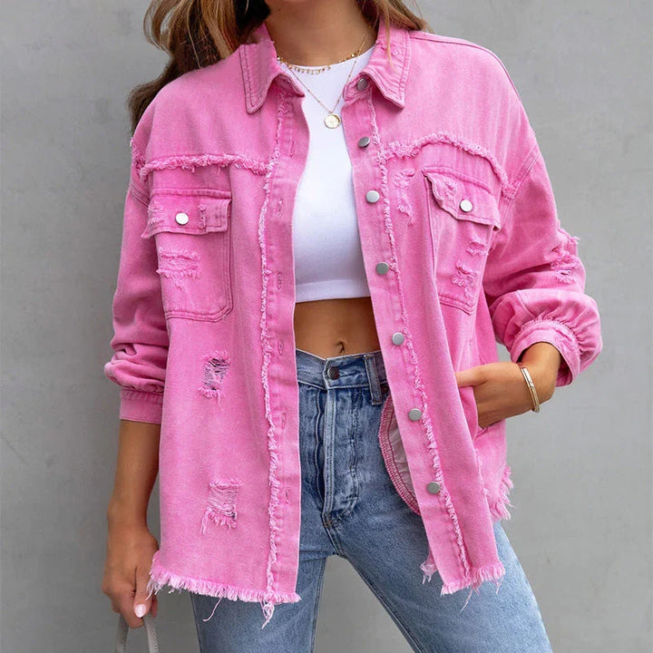 Frayed denim jacket for women, a vibrant statement piece for a distressed fashion look. Ideal for layering.
