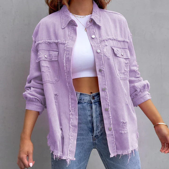 Classic women's denim jacket with frayed edges and distressed details. A stylish and versatile casual outerwear.