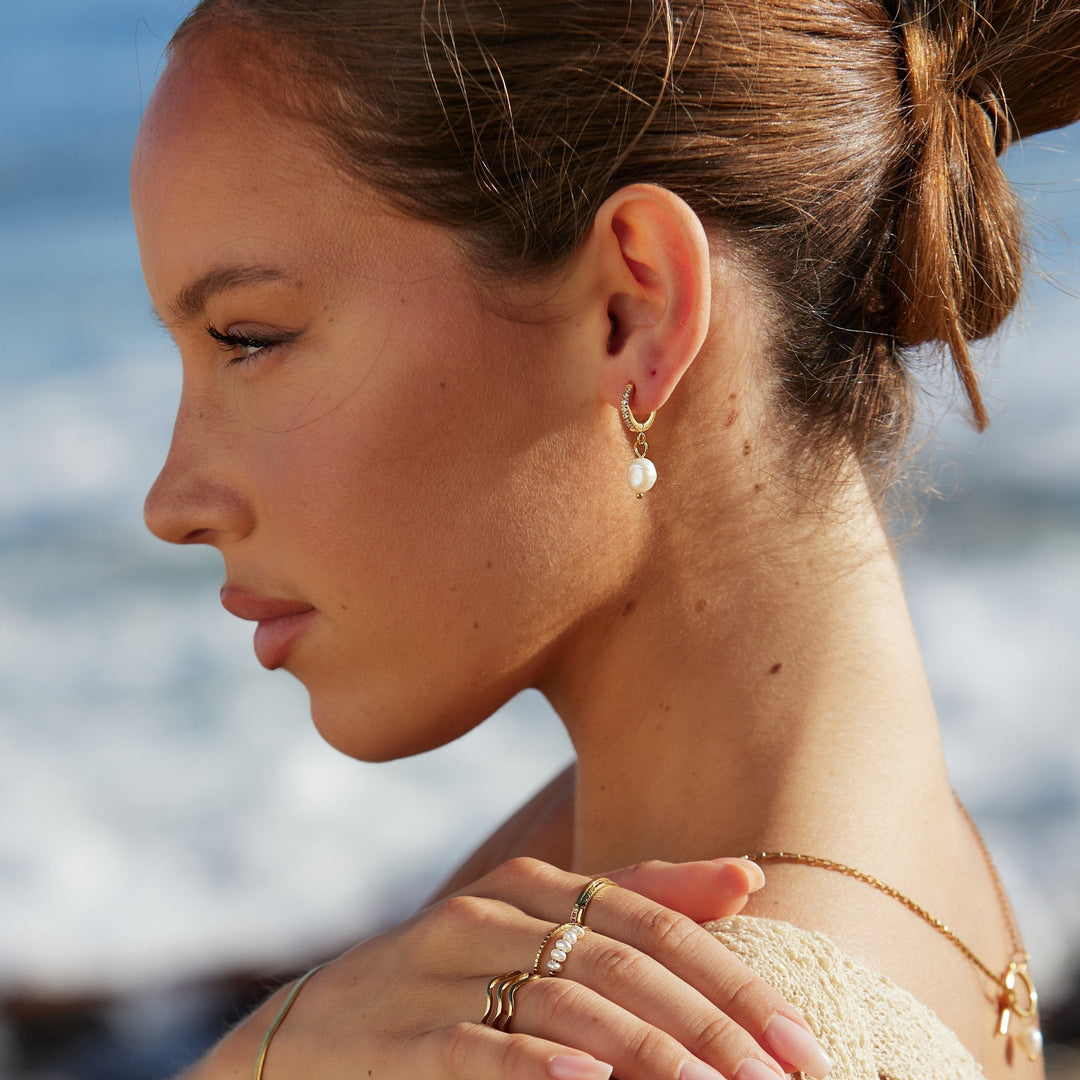 Close-up of elegant freshwater pearl hoop earrings, perfect for women's daily wear.