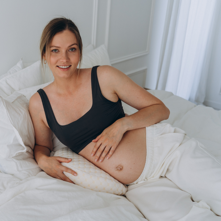 Maternity body pillow for side sleepers, offering essential back pain relief and sleep support during pregnancy.