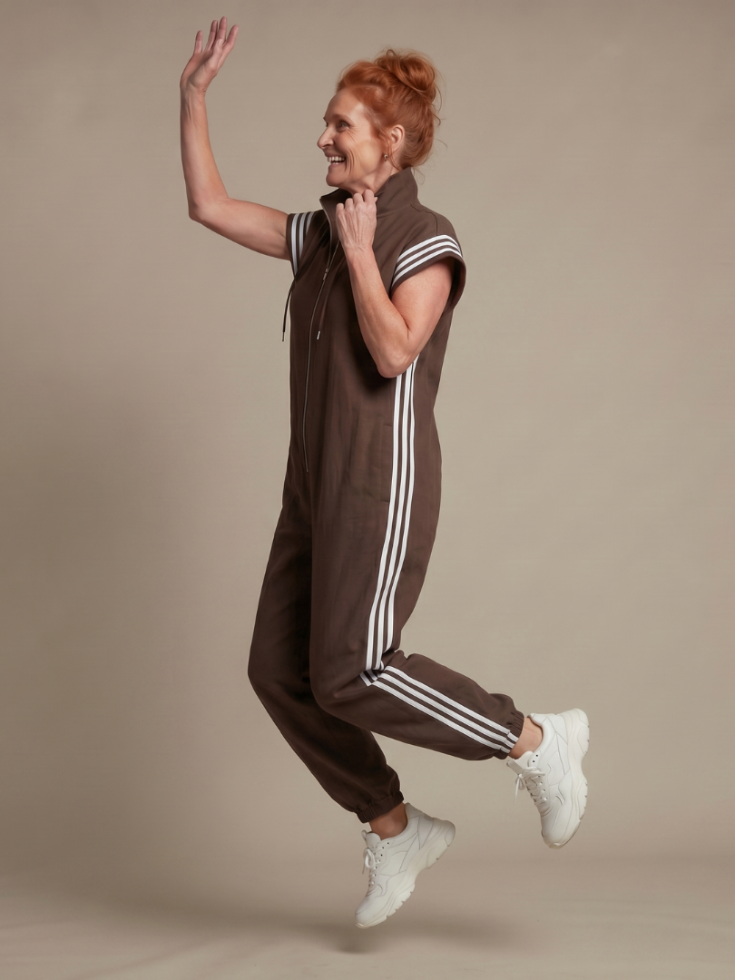Women's full-length zip jumpsuit, combining sporty chic with comfort. High neck & side stripe accents.
