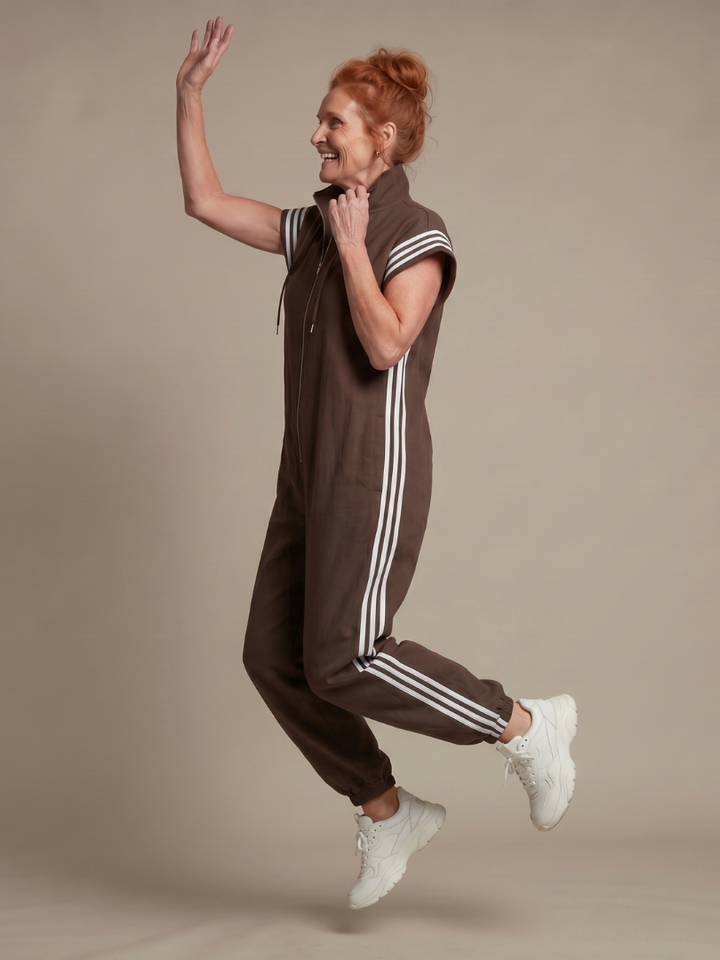 Women's full-length zip jumpsuit, combining sporty chic with comfort. High neck & side stripe accents.