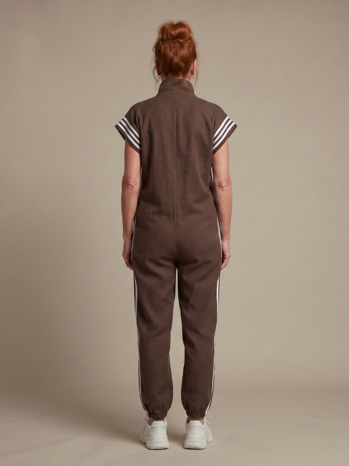 Women's full-length jumpsuit with a zip-up front, high neck, cap sleeves, & modern side stripe detail.