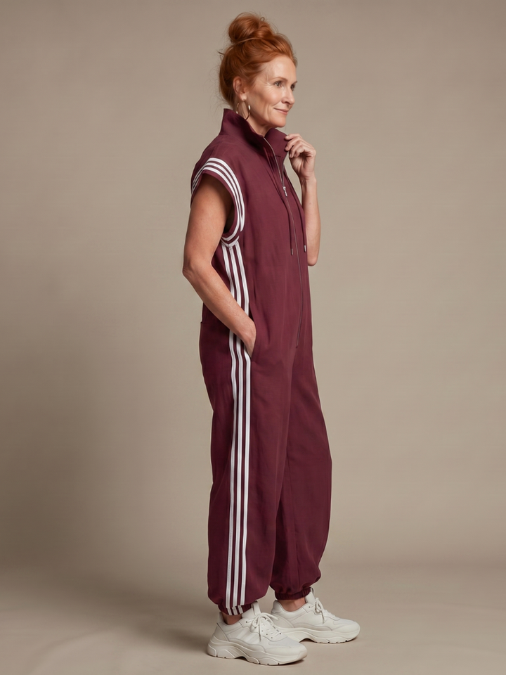 Comfortable women's full-length jumpsuit. Features a zip front, high neck, cap sleeves & side stripes.