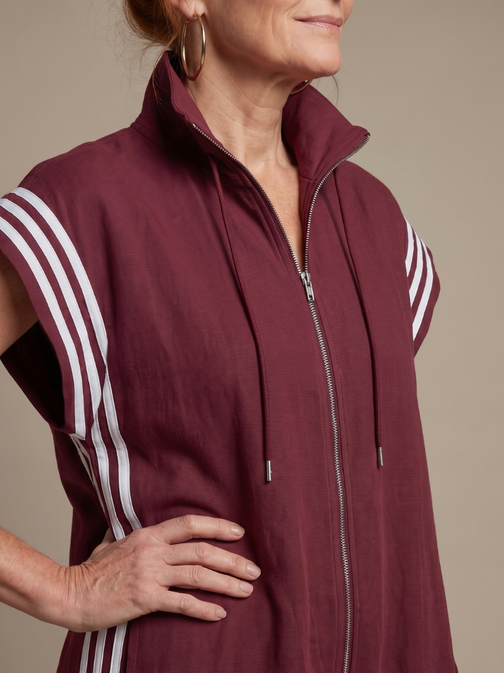 Sporty chic women's full-length jumpsuit. Zip-up front, high neck, and modern side stripe details.