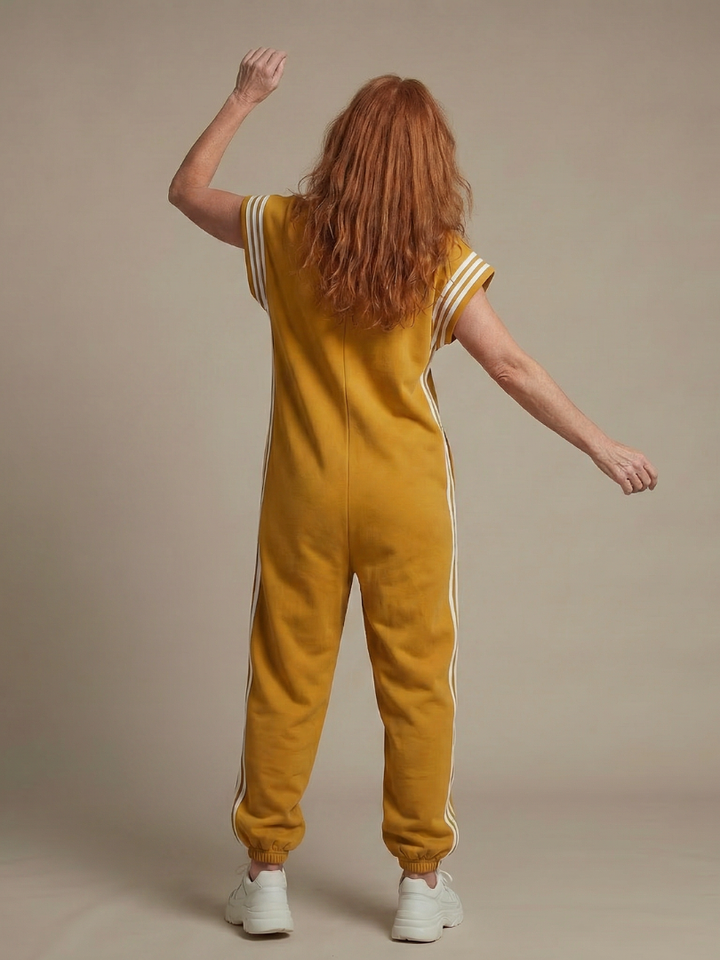 Stylish women's full-length jumpsuit with a zip front, cap sleeves, high neck, & sporty side stripes.