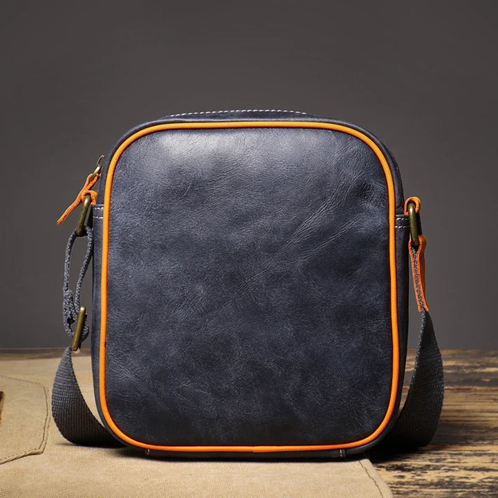 Stylish blue genuine leather crossbody purse for women, compact design with an adjustable strap.