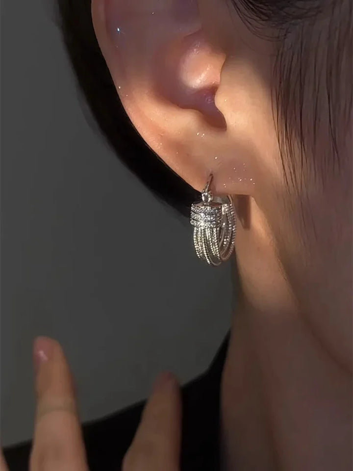 Women's geometric layered stud earrings in a modern design. Elegant fashion jewelry for women.