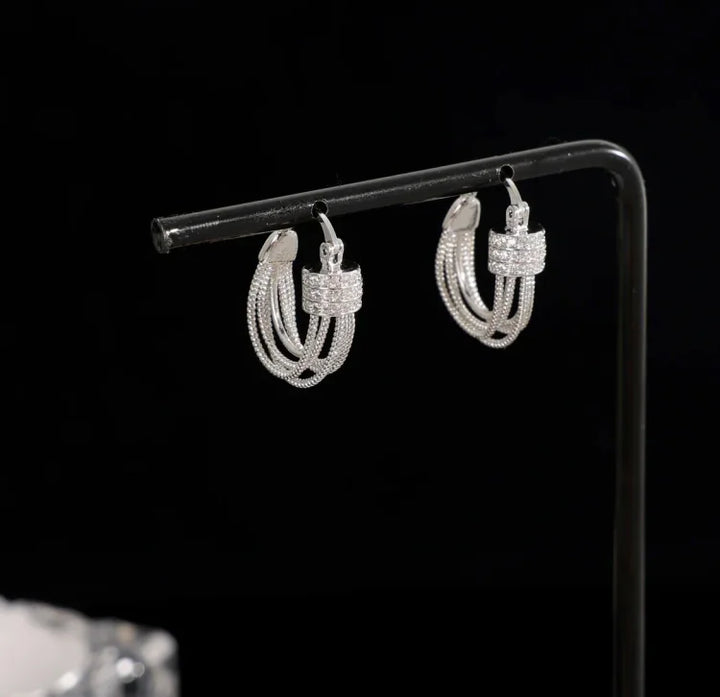 Silver geometric layered stud earrings. Elegant women's jewelry with a unique modern design.