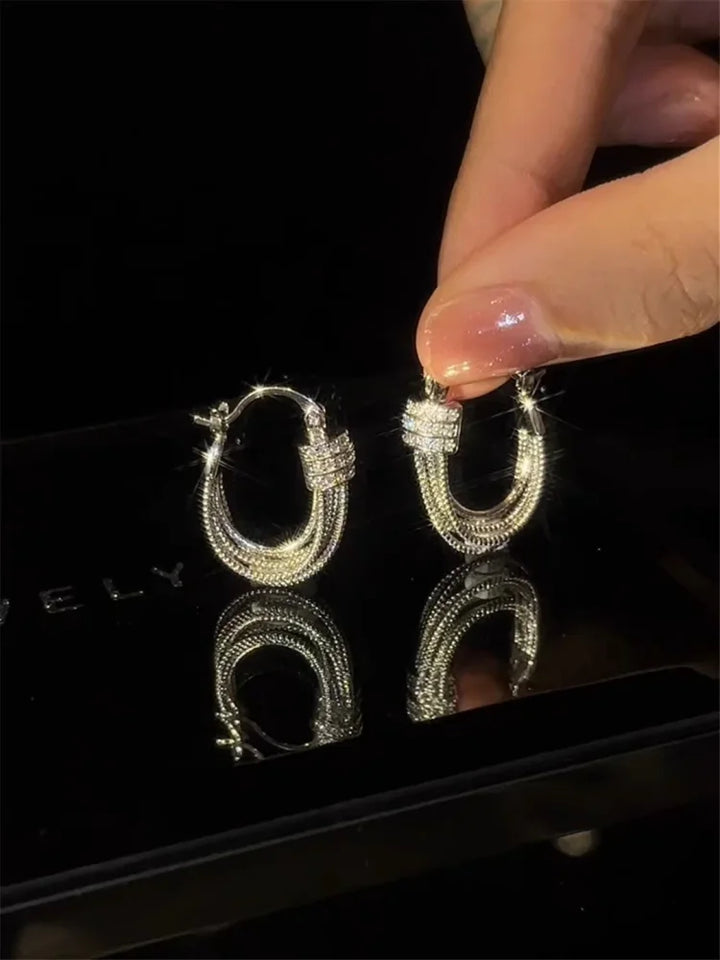 Modern geometric layered stud earrings for women. Fashionable and elegant accessory, perfect for any occasion.