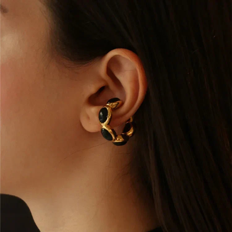Elegant women's gold-plated ring featuring a bold black onyx gemstone. Perfect versatile fashion accessory.