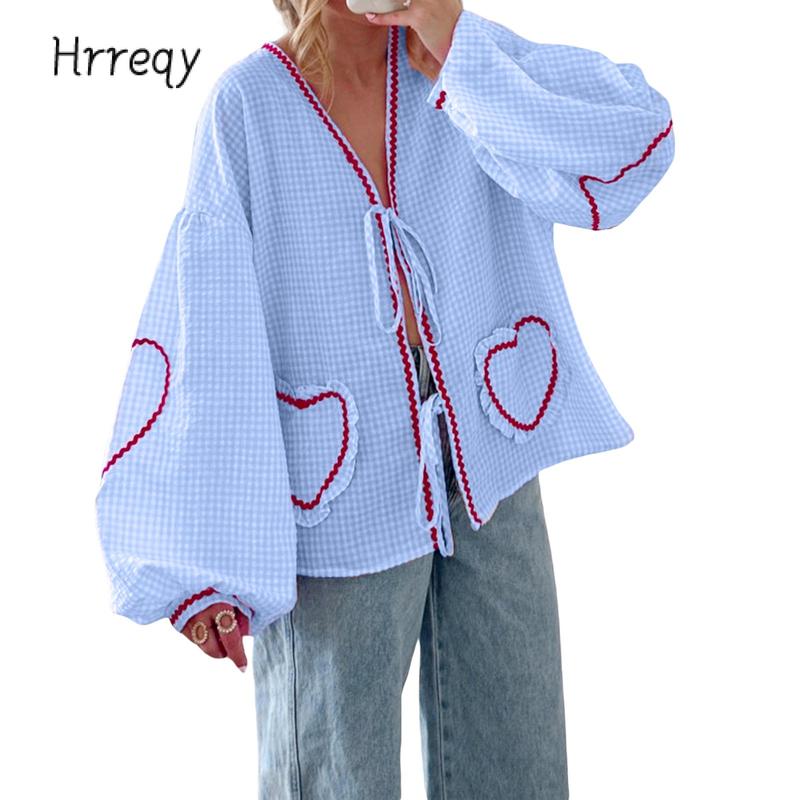 Women's gingham blouse with tie-front, heart pockets, and voluminous sleeves. Stylish & chic.