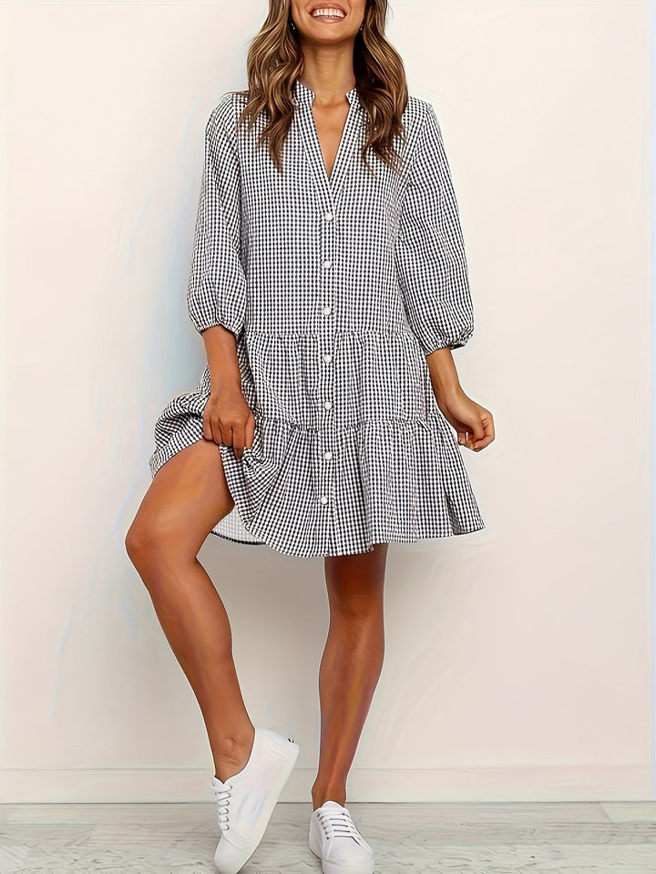 Casual women's tiered mini dress with a stylish gingham pattern and puff sleeves, ideal for summer.
