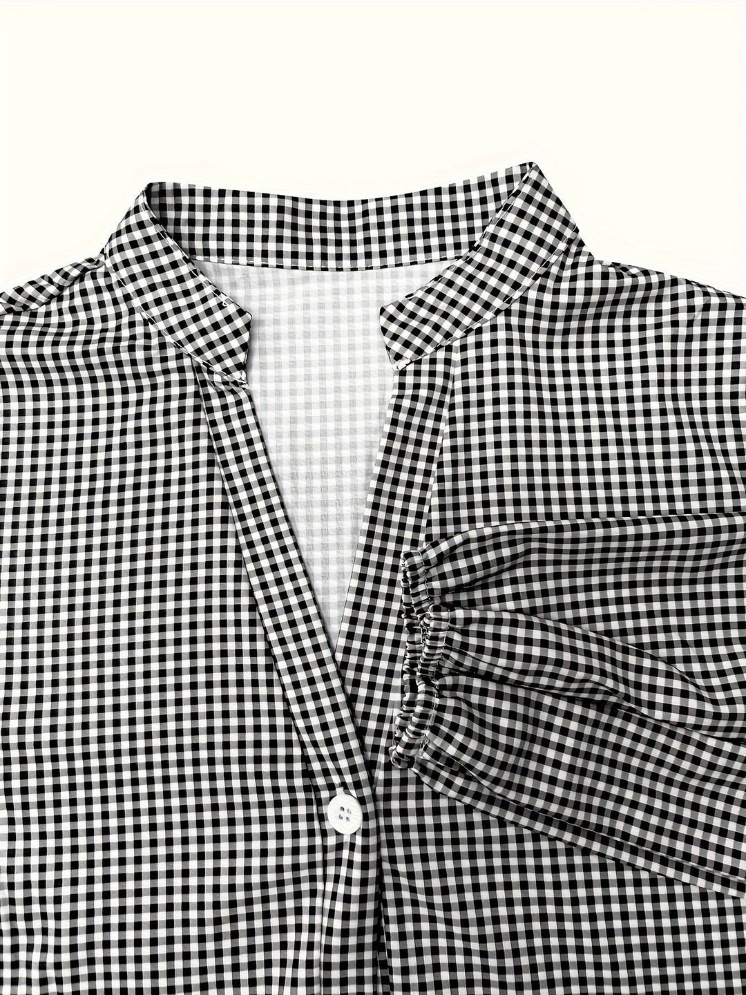 Stylish casual women's dress: a gingham tiered mini dress with puff sleeves and button-down front.