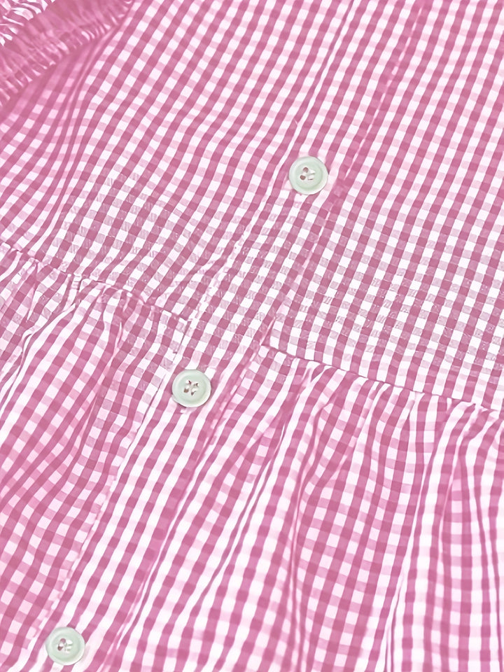 Comfortable women's tiered mini dress with a button-down front and stylish gingham print, perfect for summer.