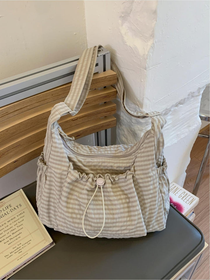 Women's gingham cotton canvas shoulder bag with a comfy padded strap for daily use.