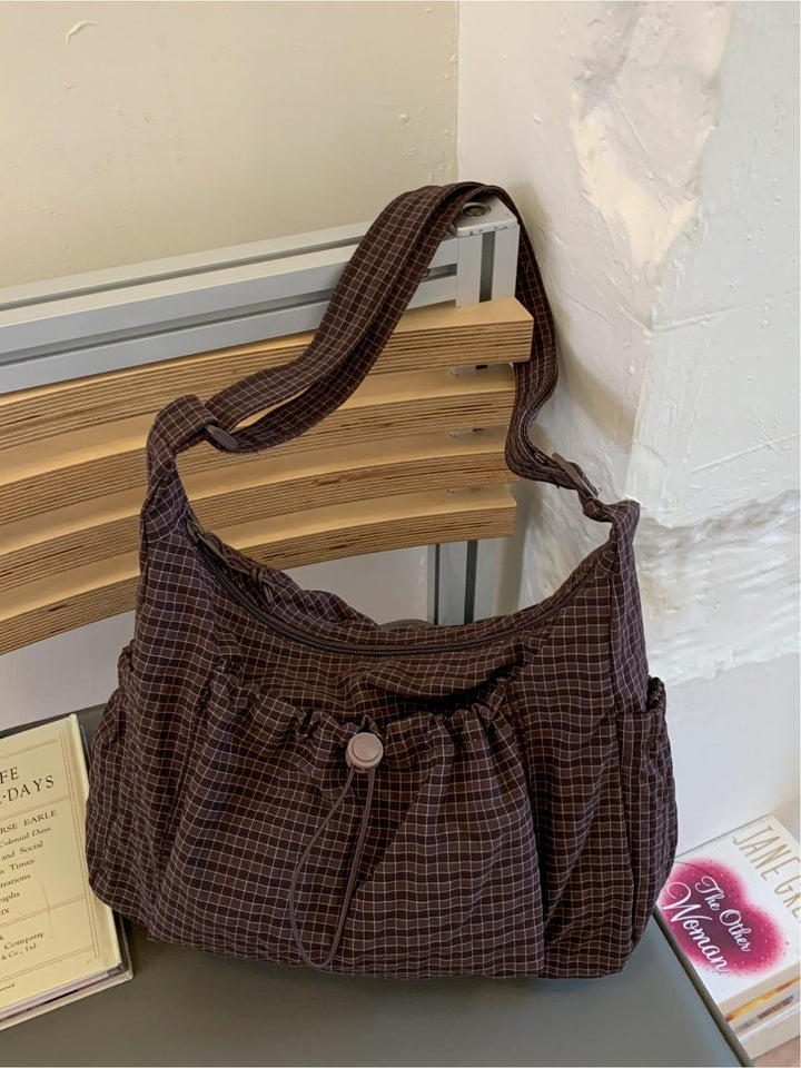 Casual women's shoulder bag: chic gingham cotton canvas design, padded strap for comfortable carrying.