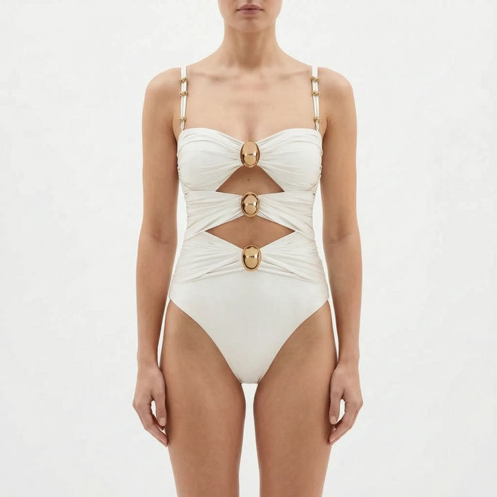 Overhead shot of women's stylish cutout one-piece swimsuit. Essential summer beachwear & resort outfit.