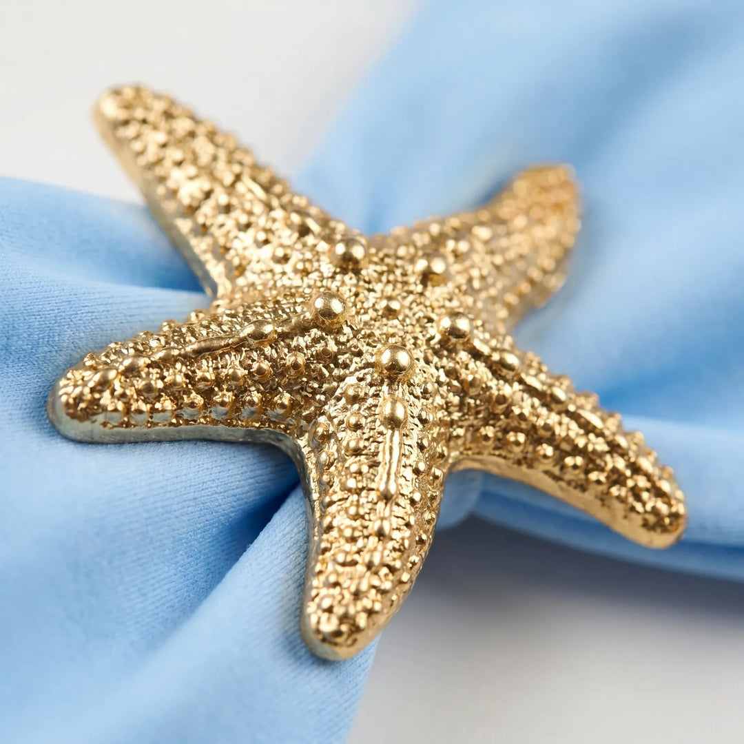 Close-up of glamorous women's cutout swimsuit featuring unique starfish accents. Chic beach fashion.