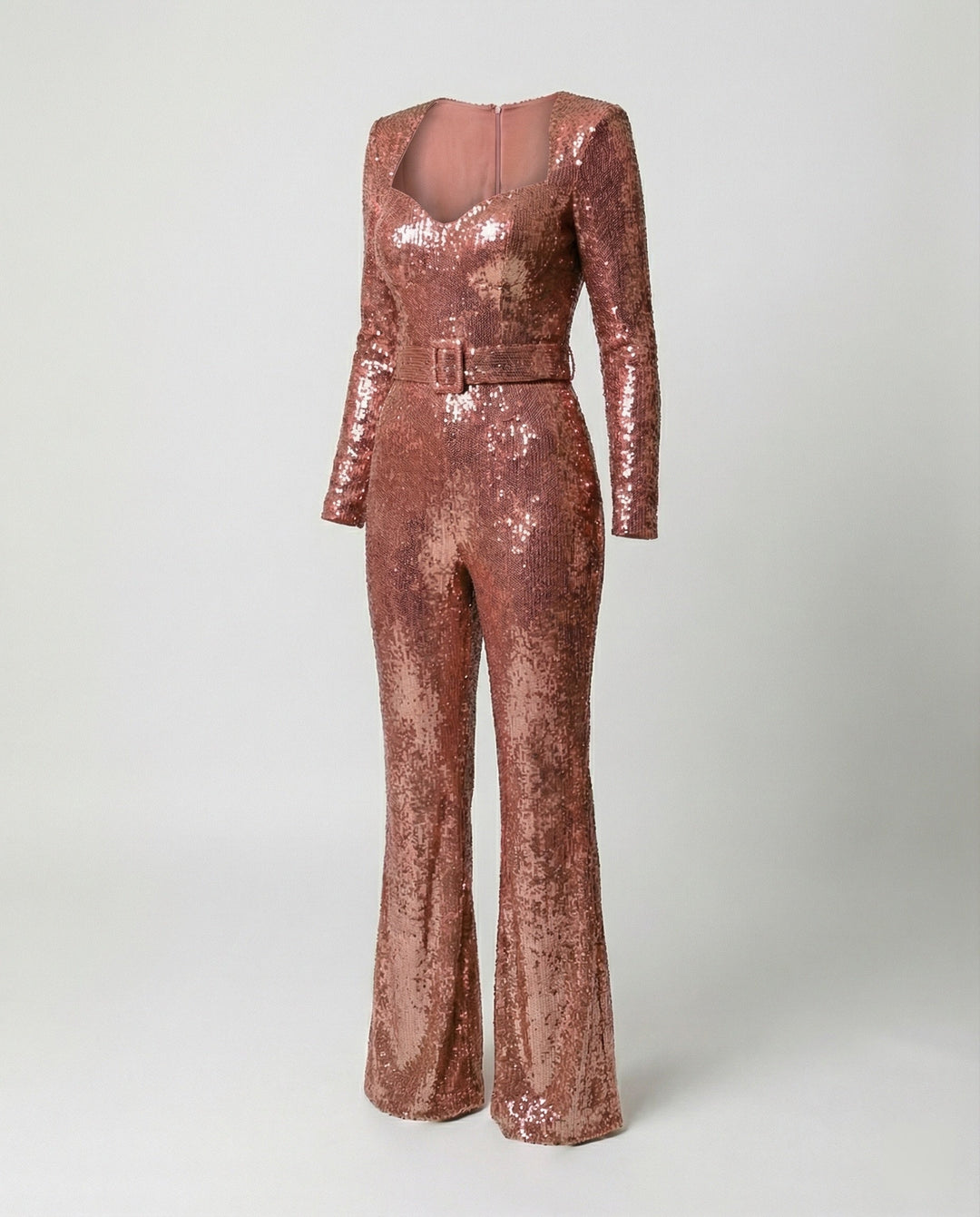 Close-up of shimmering sequins on a long-sleeve women's glamorous jumpsuit, perfect for evening events.