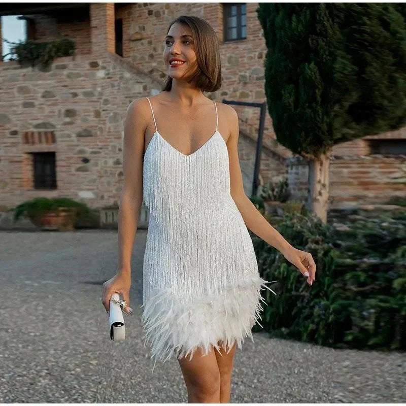 Elegant women's short sequin cocktail dress featuring a chic feather trim and spaghetti straps.