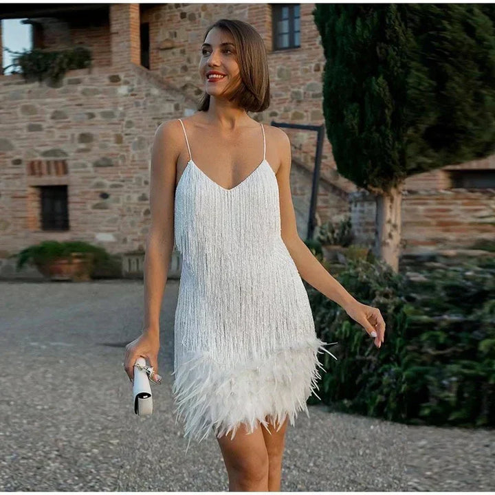 Elegant women's short sequin cocktail dress featuring a chic feather trim and spaghetti straps.
