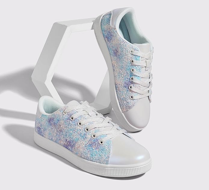 Model wearing women's glitter lace-up sneakers with jeans, trendy casual footwear