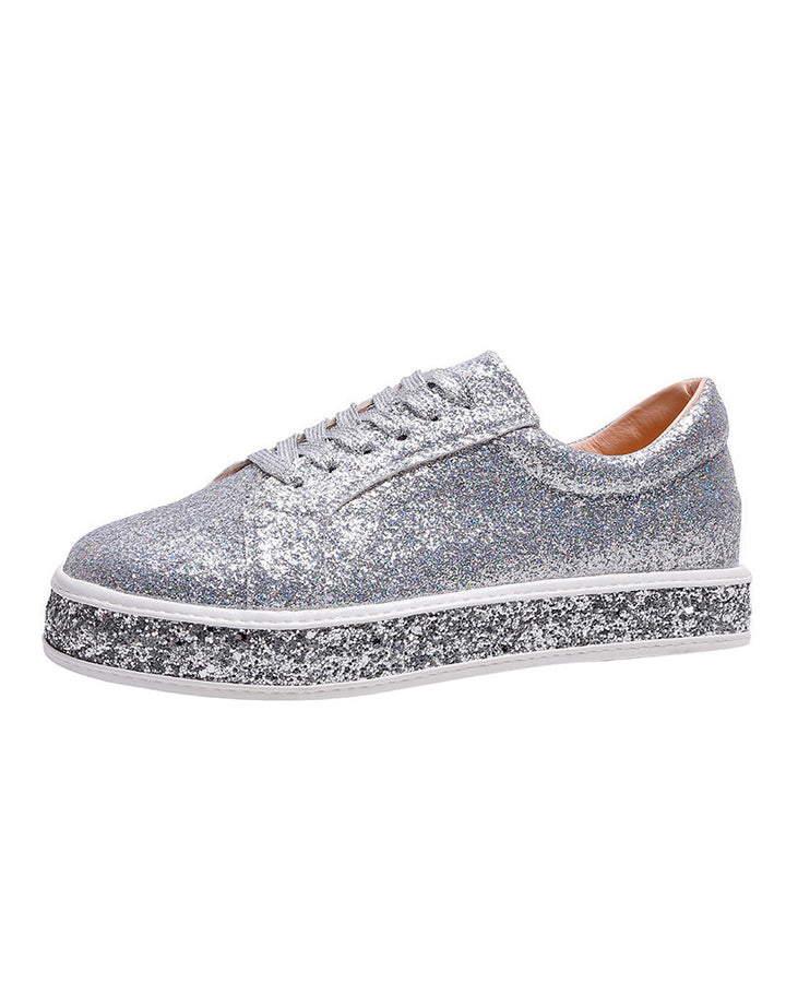 Elegant women's platform sneakers with subtle glitter, providing a chic and comfortable footwear option.