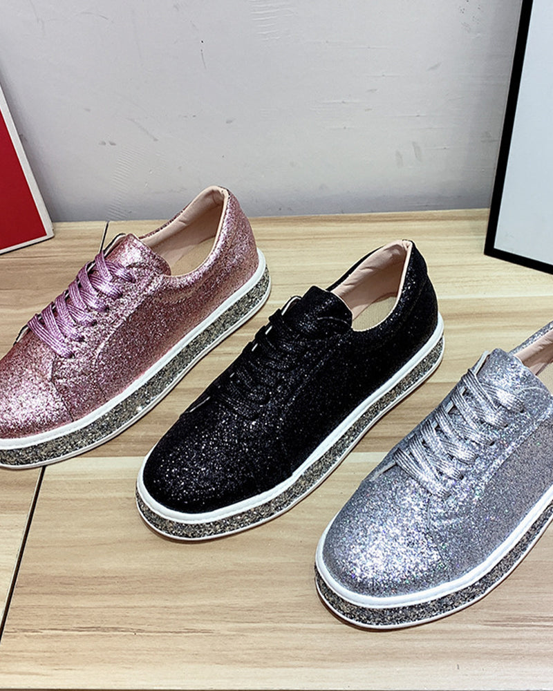Side view of black women's glitter platform sneakers, showcasing the thick sole and shimmering detail.