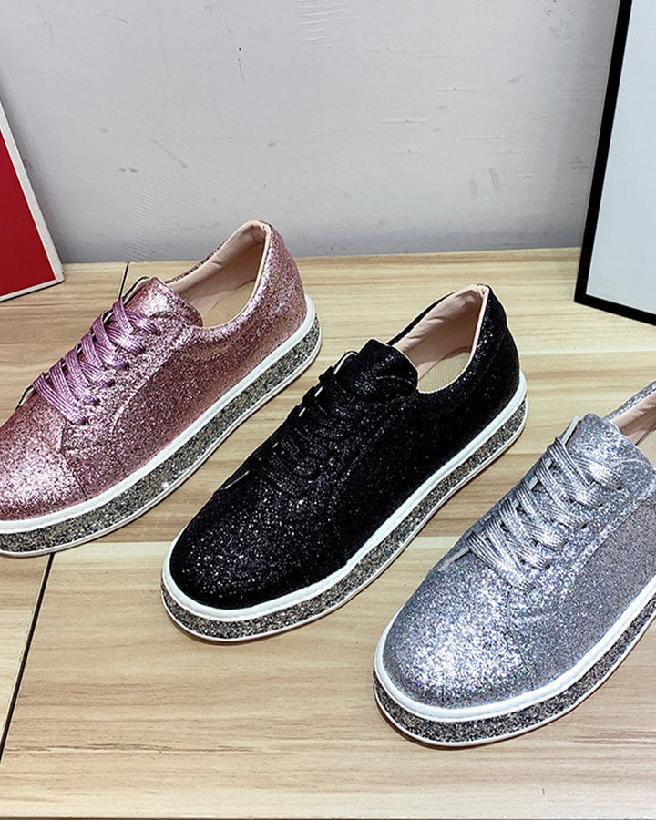 Side view of black women's glitter platform sneakers, showcasing the thick sole and shimmering detail.