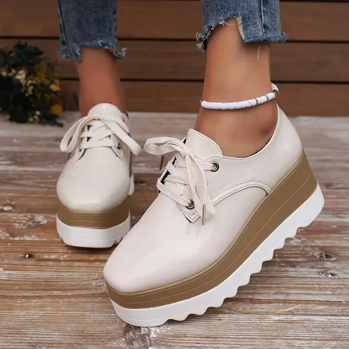 Fashionable women's glossy platform sneakers, elevating any outfit with trend-setting design & comfort.