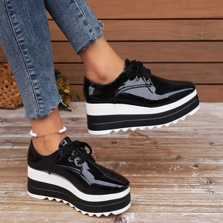 Lace-up detail on women's glossy platform fashion sneakers, ensuring a secure & comfortable fit.