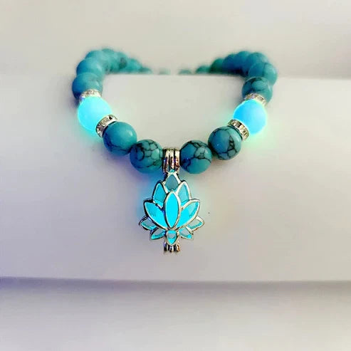 Women's glow-in-the-dark lotus bracelet, elegant luminous charm jewelry.