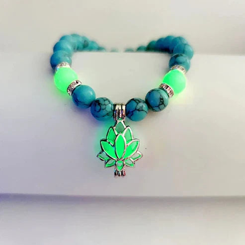 Elegant women's bracelet with a glowing lotus charm, unique luminous jewelry style.