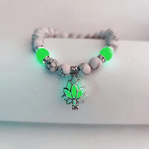 Delicate glowing lotus bracelet for women, luminous floral charm jewelry.