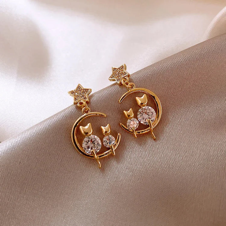 Sparkling gold cat ear earrings for women, featuring brilliant zirconia gems. Chic feline studs for any animal lover.
