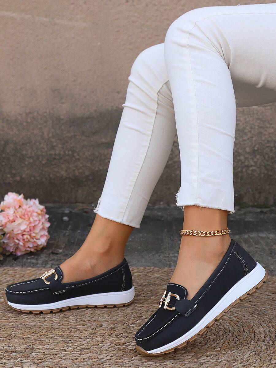 Modern classic women's flatform loafers with sophisticated gold chain. Easy slip-on style for all-day comfort.
