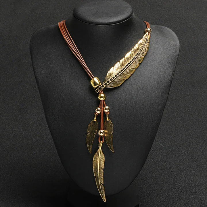 Women's gold feather necklace. Delicate boho charm jewelry with an adjustable chain, perfect for everyday wear.
